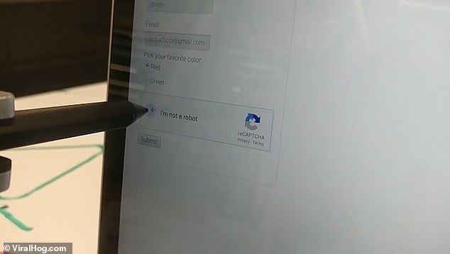 The security exists to stop automated systems from abusing online services, but the robot easily holds the stylus in place long enough for the green tick to appear