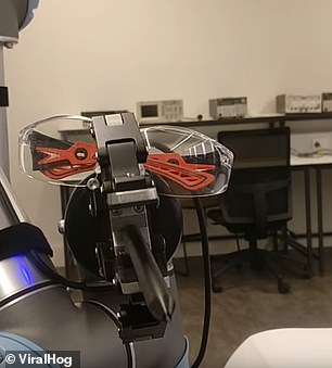 Armed with a funky pair of glasses, the robot opens its mouth-like clamp to 